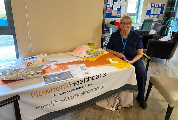 A nurse sat at a table waiting for patients