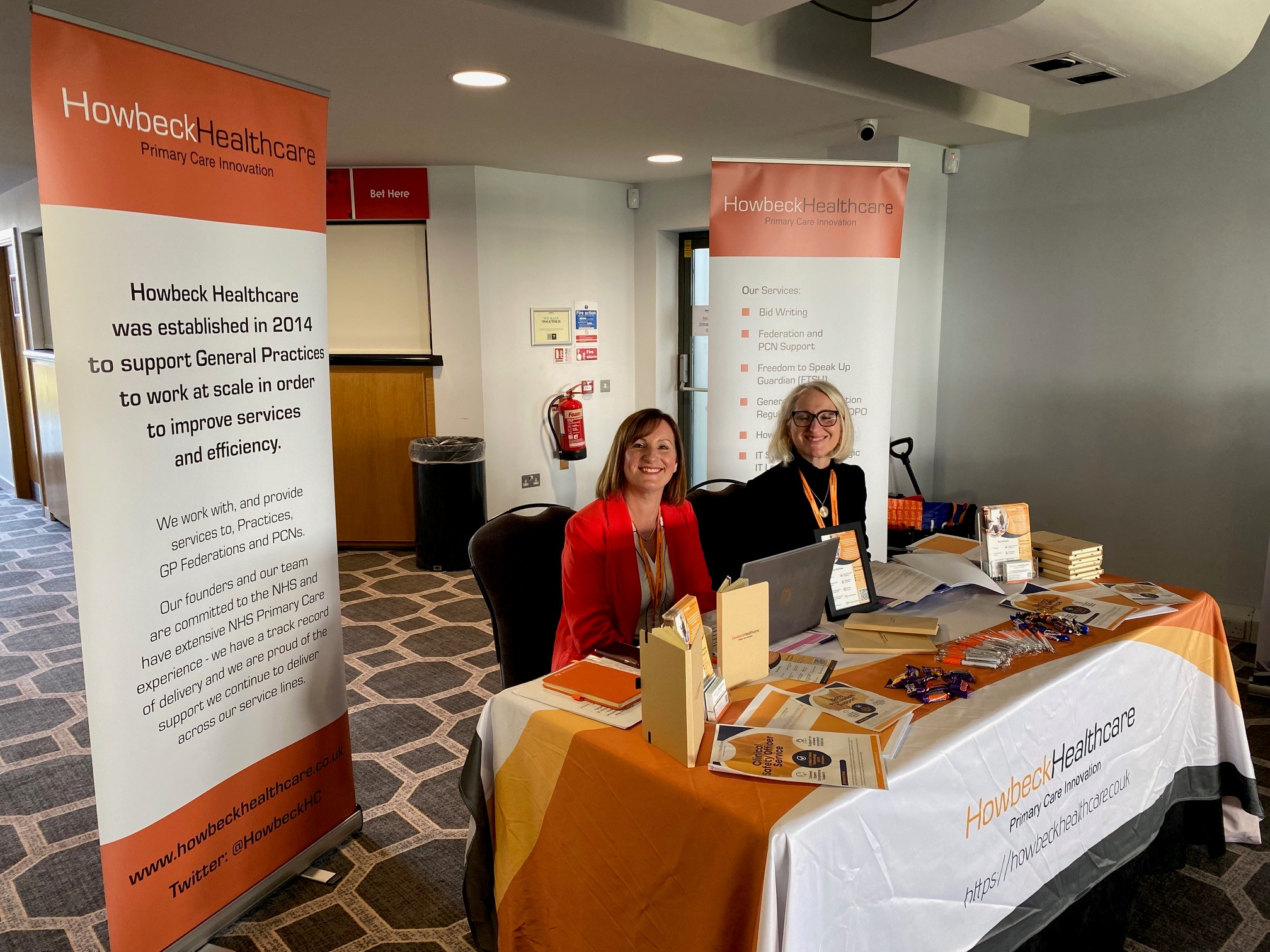 Lisa Taylor and Edy Hicklin sat behind a table at the Howbeck stand during a conference.